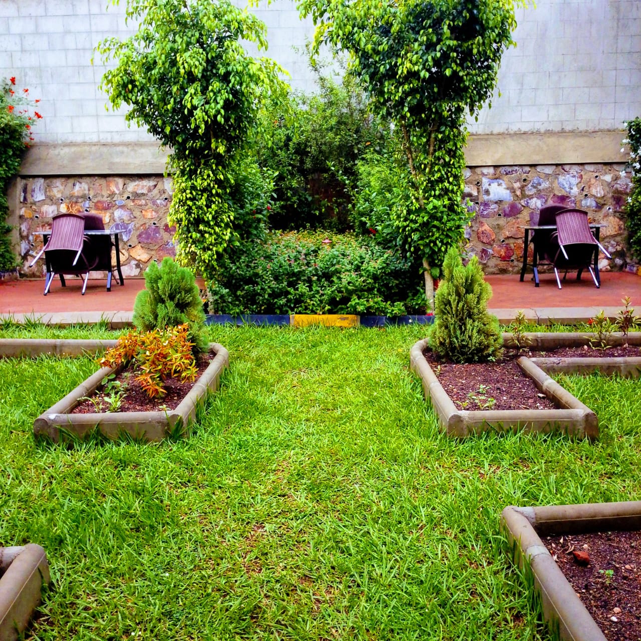 Akengyeya Country Hotel well-kept lawn and garden area for outdoor relaxation